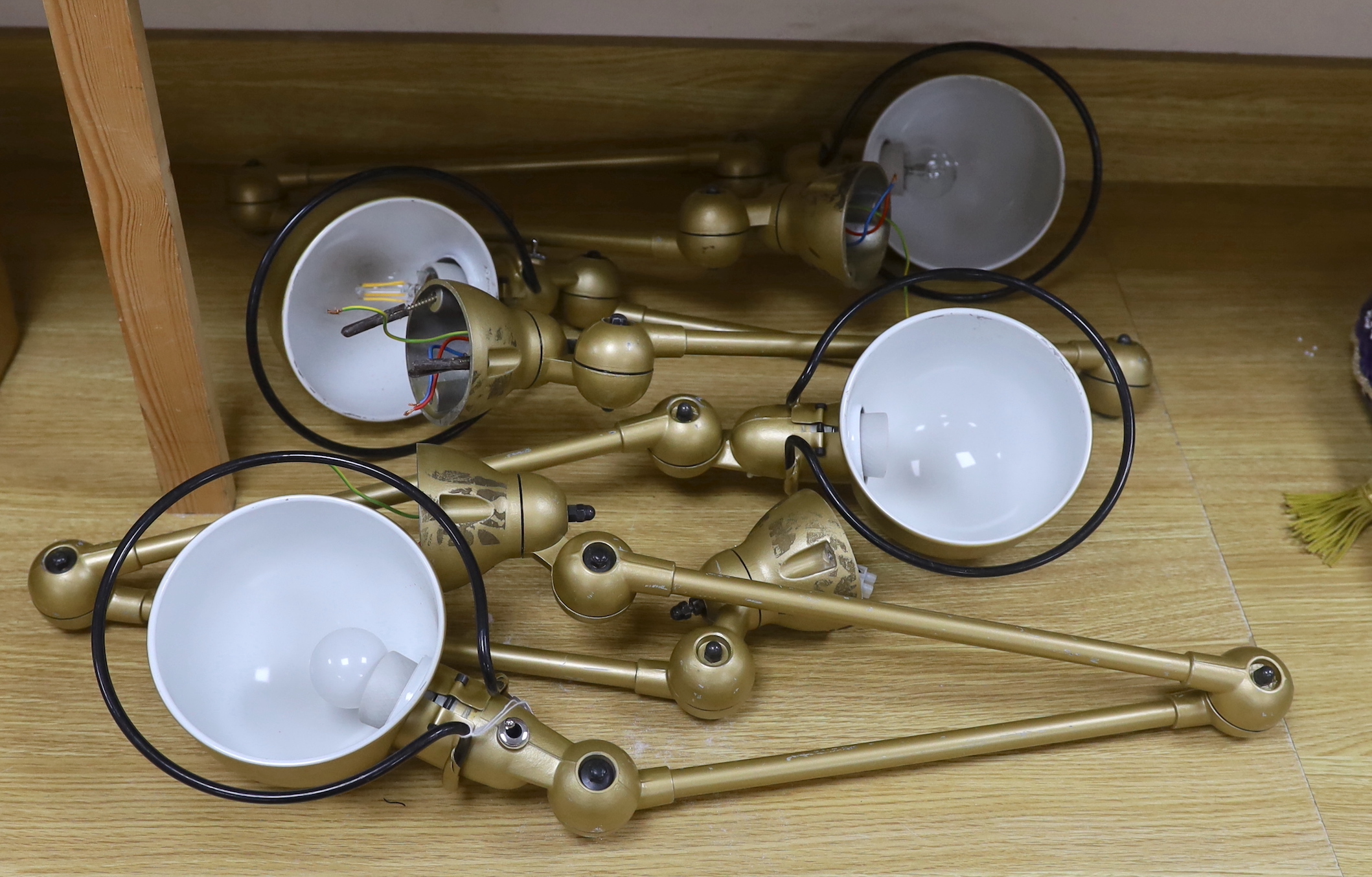 Set of four gilt painted anglepoise lamps, 117cm in length when extended